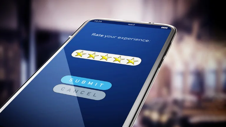 Close-up of a smartphone screen showing a five-star customer review submission form, symbolizing positive feedback and high-quality service experience.