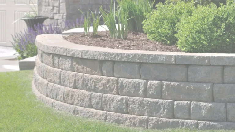 Curved block retaining wall in a Southern California garden built by expert contractors to enhance landscaping and prevent soil erosion.