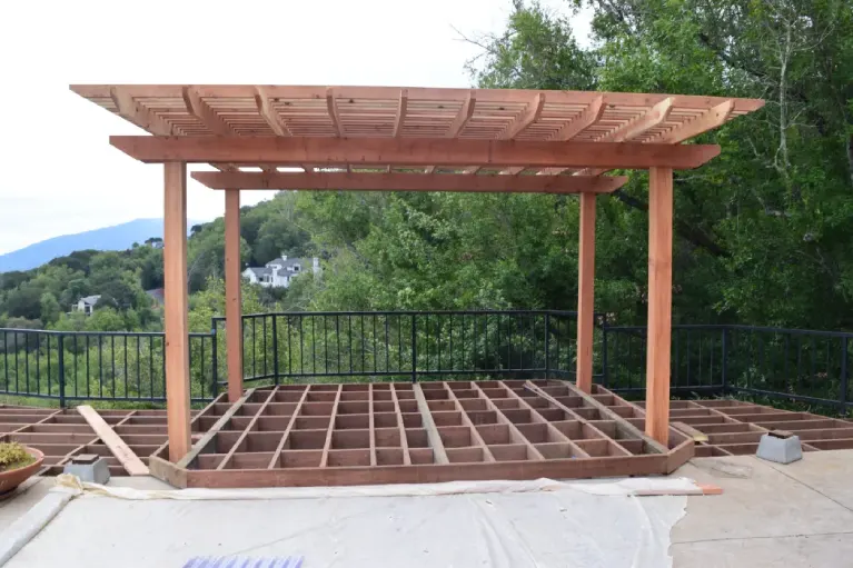 Framing of a hillside deck with a pergola in progress—showcasing expert construction techniques for sloped properties in Southern California.