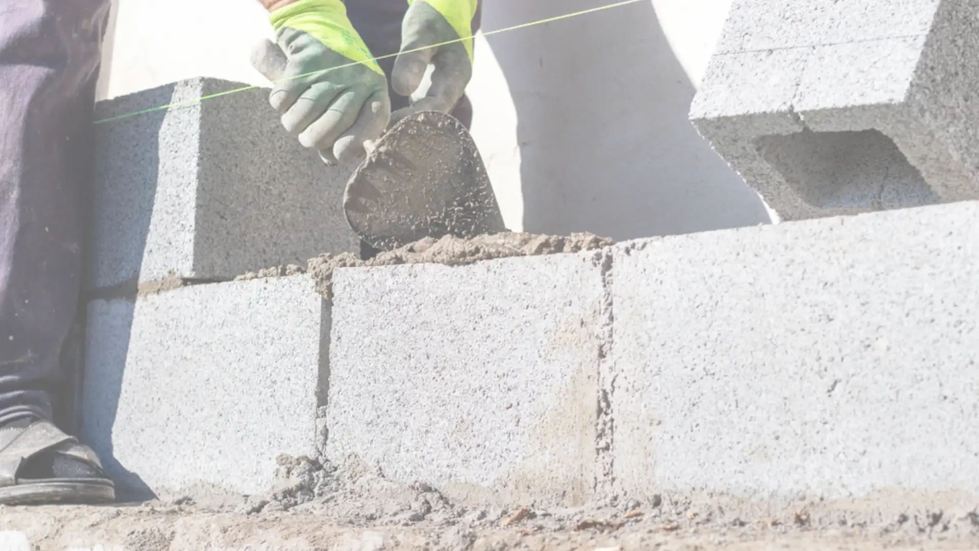 Masonry contractor in Southern California laying concrete blocks with precision for a durable wall installation.