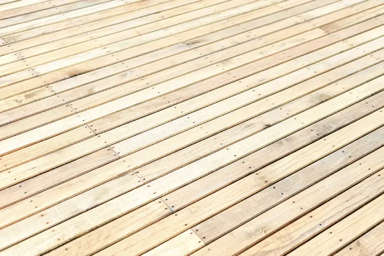 Close-up of natural wood deck boards in Huntington Beach—highlighting the beauty and durability of real wood for long-lasting outdoor spaces.