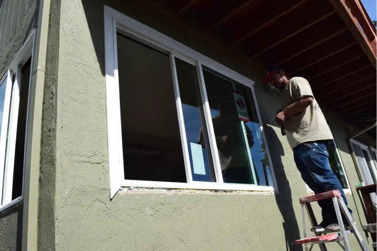 Contractor installing energy-efficient windows in Oceanside to improve home insulation, protection, and curb appeal.