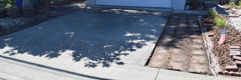 Cracked residential concrete driveway in need of professional repair and resurfacing in Southern California
