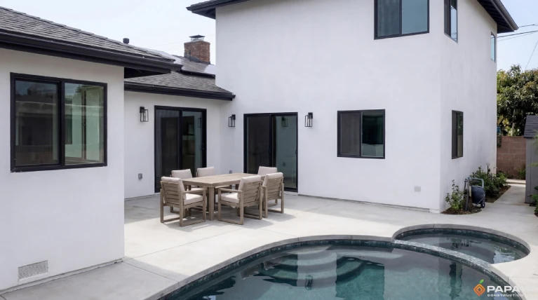 backyard pool area with modern exterior design and updated stucco finish in Garden Grove California