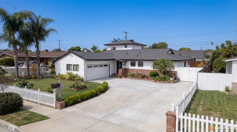 fully renovated home exterior with white stucco black windows and new roof in Garden Grove California