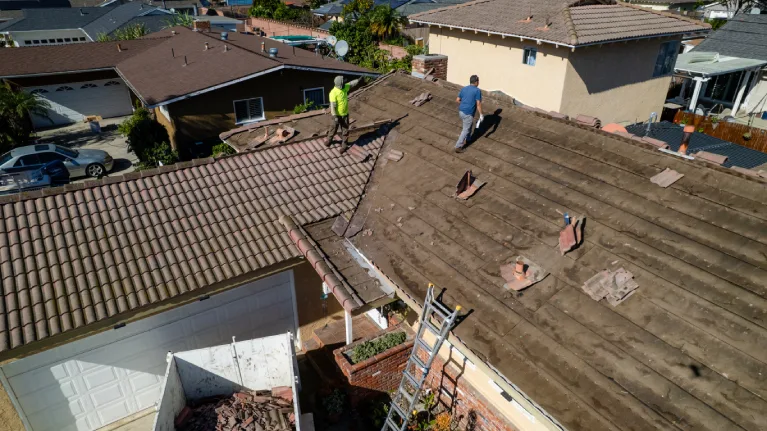 old roofing shingles being removed during roof replacement project in Garden Grove California before installation