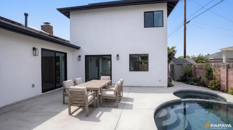 modern home exterior with white stucco finish and black framed windows in Garden Grove CA after renovation