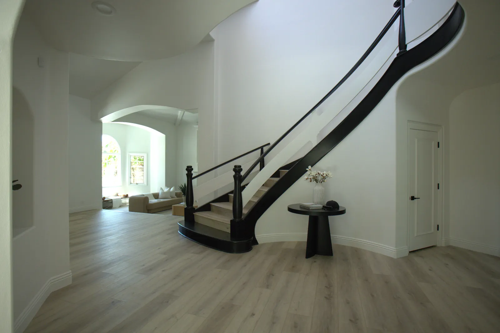 Wide plank luxury vinyl flooring through entry hall and staircase, Laguna Hills renovation