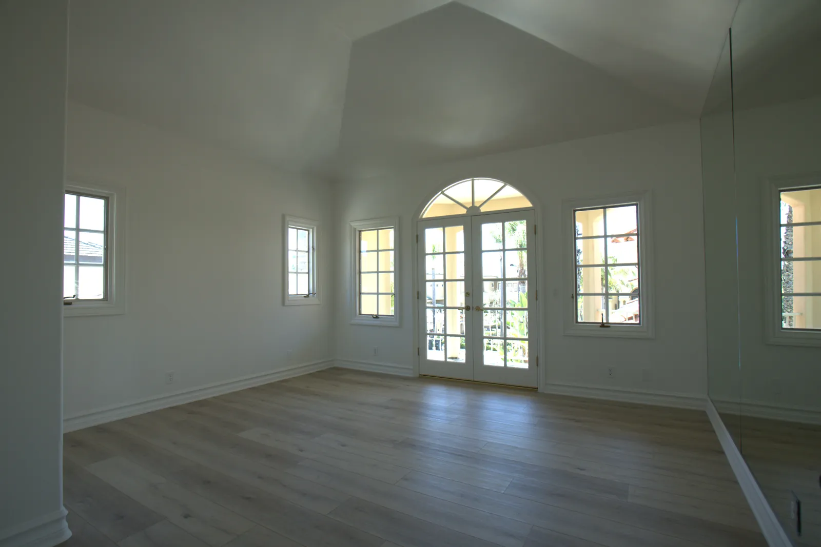 New wide-plank LVP flooring and replacement windows with French doors, Laguna Hills bedroom